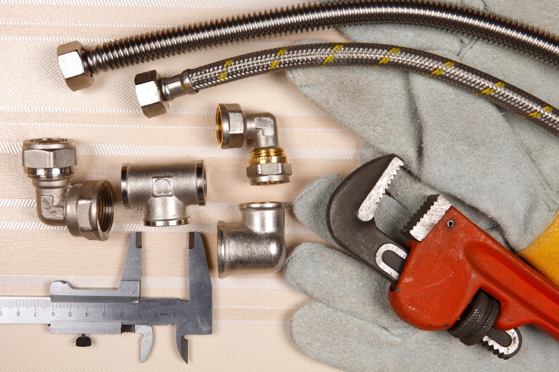 Plumber working on pipes in a Teddington home